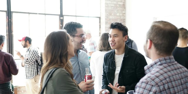 Product School | Unsplash Four people at a conference.